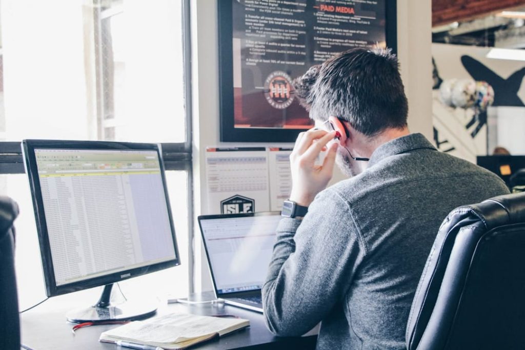 Ensuring Data Security and Compliance With Cloud Faxing 4 Male employee securely sending documents via cloud faxing for enhanced data protection.